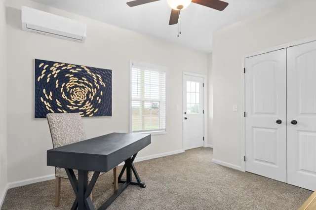 a view of a room that has a table and chairs