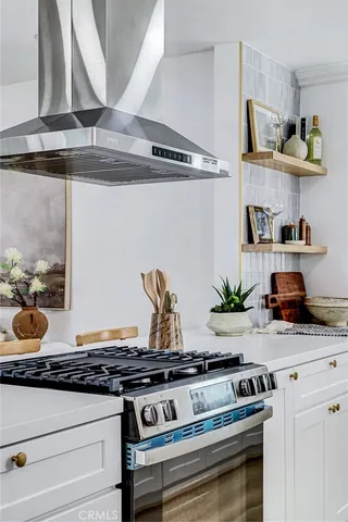 a stove top oven sitting inside of a kitchen
