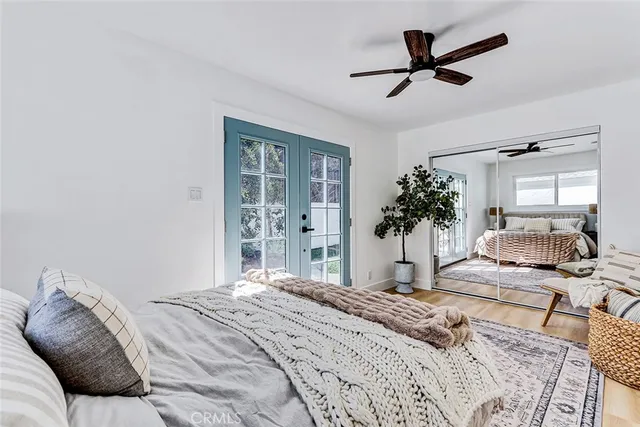 a bedroom with a large bed and a chandelier