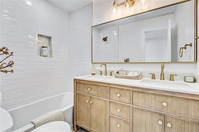 a bathroom with a granite countertop toilet sink and a mirror