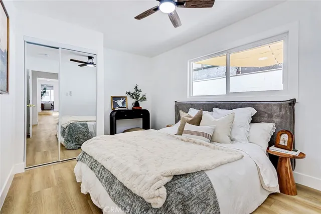 a bedroom with a bed and wooden floor