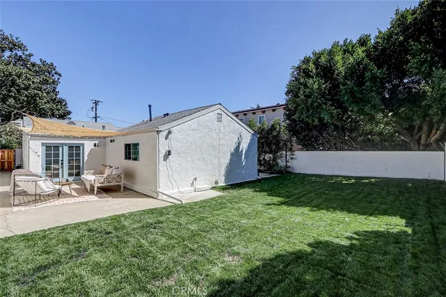 a view of a backyard with sitting area and garden