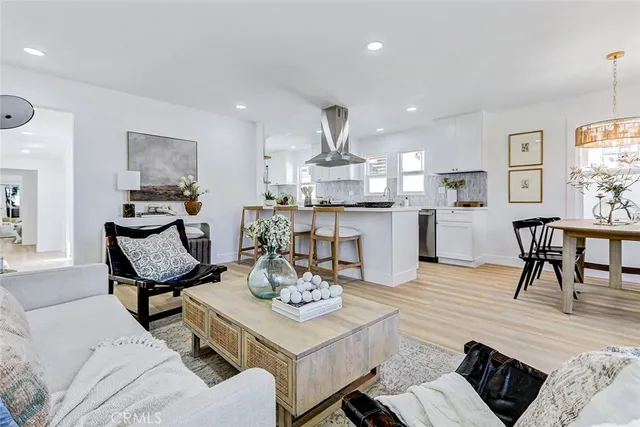 a living room with furniture and kitchen view