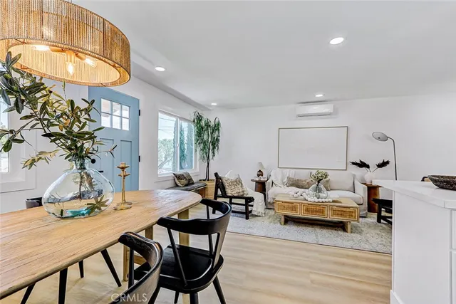 a living room with furniture a table and a potted plant