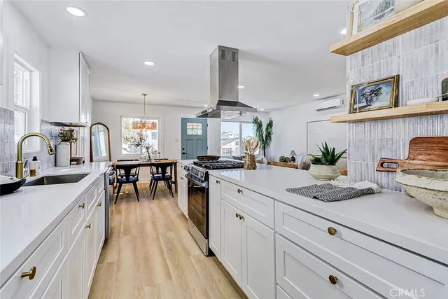 a kitchen with sink stove and cabinets