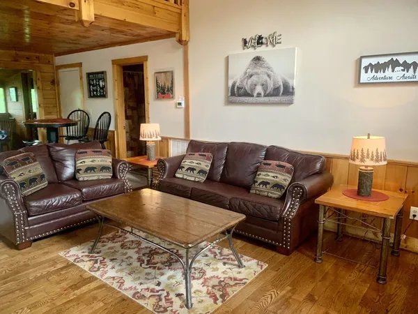a living room with furniture and a rug