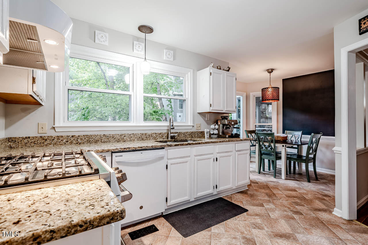8 Wexford Drive Durham, NC 27713 - Photo 11 of 38 a kitchen with stainless steel appliances granite countertop a stove a sink and a microwave