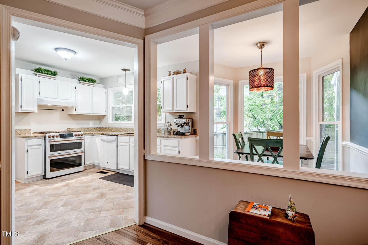 8 Wexford Drive Durham, NC 27713 - Photo 13 of 38 a kitchen with stainless steel appliances kitchen island wooden cabinets and a refrigerator