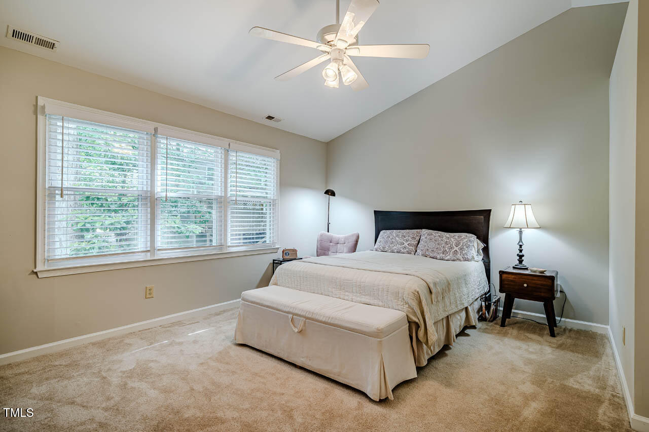 8 Wexford Drive Durham, NC 27713 - Photo 20 of 38 a spacious bedroom with a bed and a chandelier