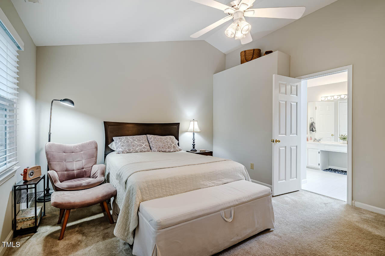 8 Wexford Drive Durham, NC 27713 - Photo 21 of 38 a bedroom with a bed and a chandelier