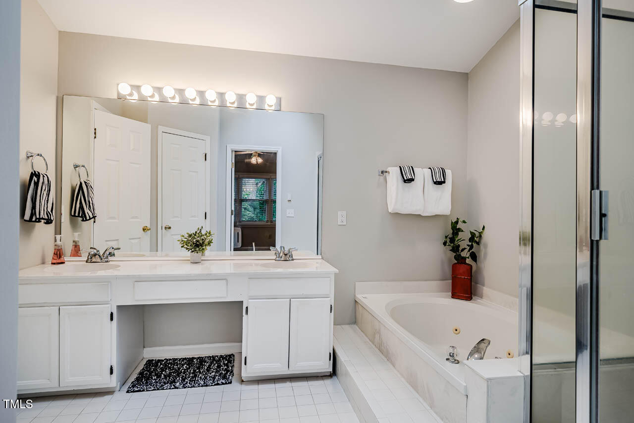 8 Wexford Drive Durham, NC 27713 - Photo 23 of 38 a bathroom with a tub sink and mirror