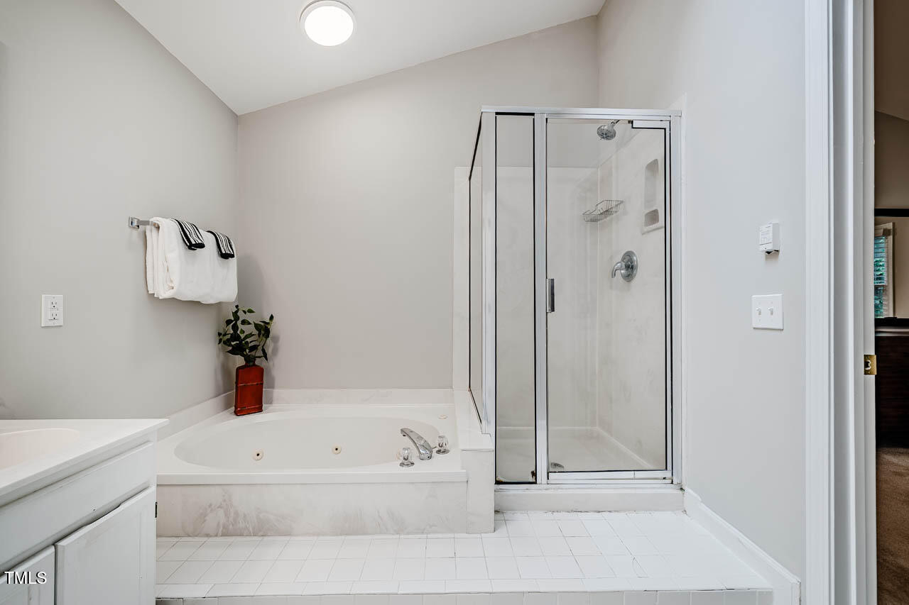 8 Wexford Drive Durham, NC 27713 - Photo 24 of 38 a bathroom with a bathtub and a shower