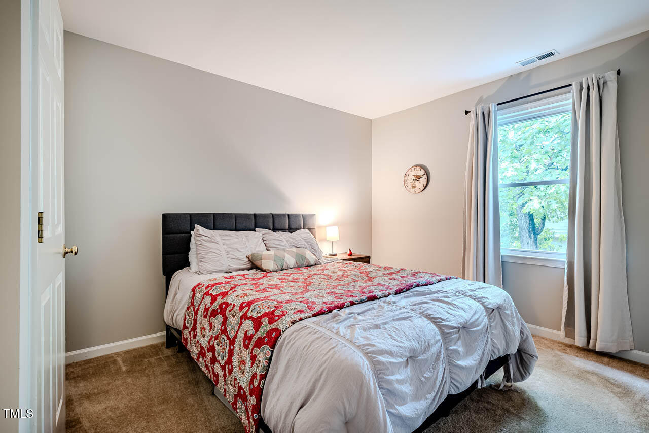 8 Wexford Drive Durham, NC 27713 - Photo 25 of 38 a bedroom with a bed and a window