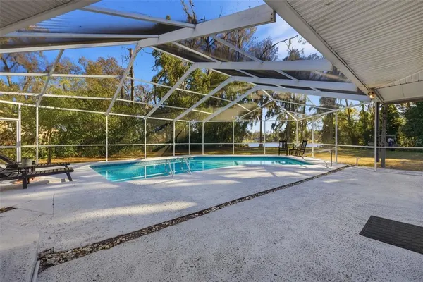 a view of a house with a yard and sitting area