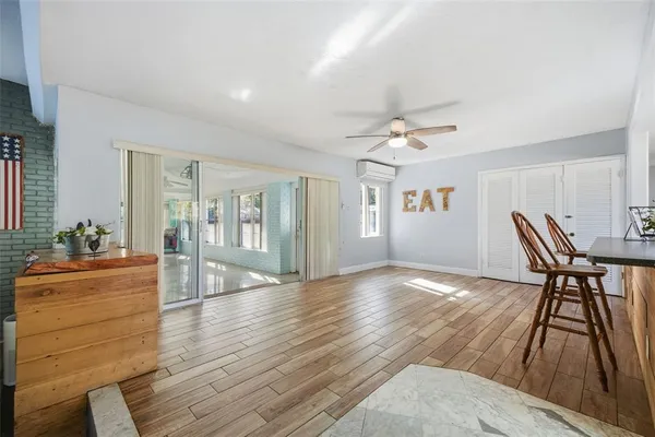 a living room with furniture and kitchen view