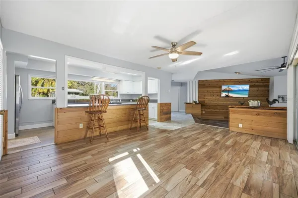 a large white kitchen with a lot of counter space and a sink