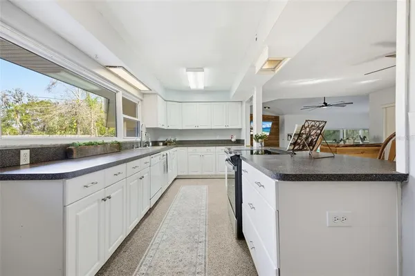 an empty room with windows and fireplace