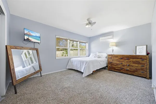 a bathroom with a granite countertop sink a toilet and a mirror