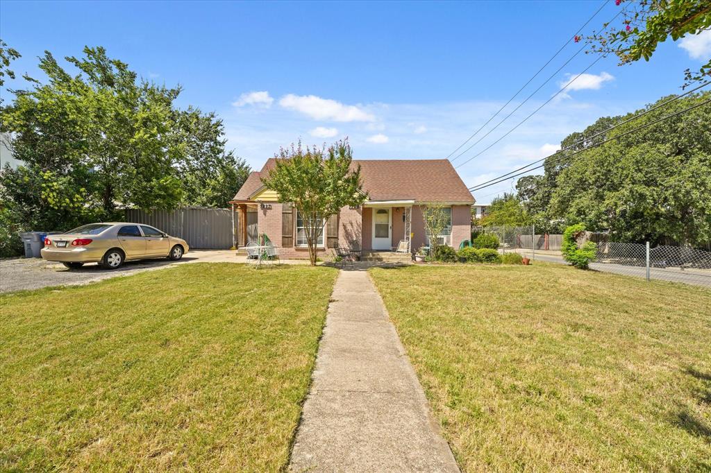 7225 Mohawk Drive Dallas, TX 75235 - Photo 5 of 16 a front view of a building with trees