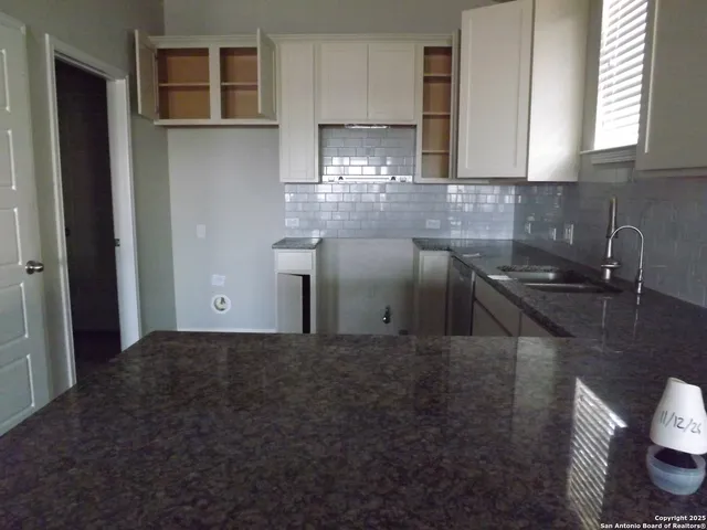 a kitchen with a sink and cabinets