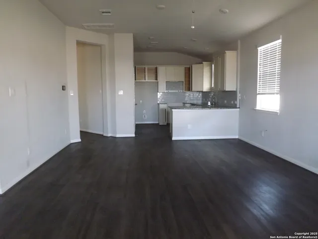 a view of open kitchen with wooden floor and window