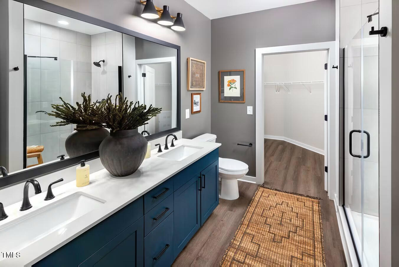 821 Hanbury Way, Unit A1 1 Raleigh, NC 27607 - Photo 11 of 43 a spacious bathroom with a double vanity sink and a mirror