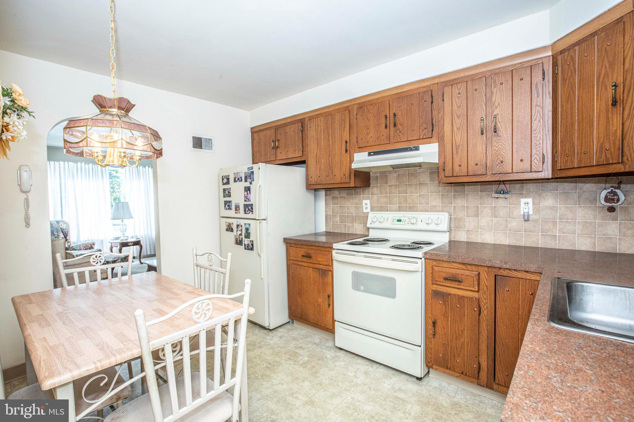 3328 Stoudts Ferry Bridge Road Reading, PA 19605 - Photo 15 of 29 a kitchen with stainless steel appliances granite countertop a stove a sink dishwasher and a refrigerator with wooden cabinets