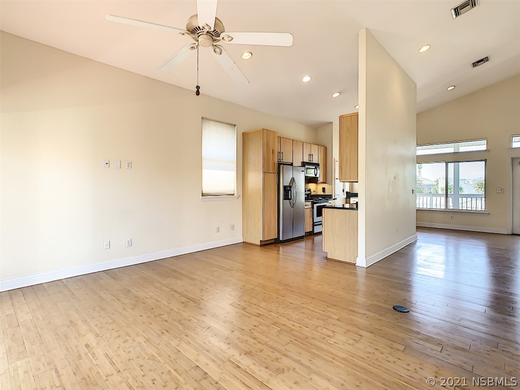 6273 Engram Road New Smyrna Beach, FL 32169 - Photo 11 of 34 a view of a kitchen with a stove cabinets and wooden floor
