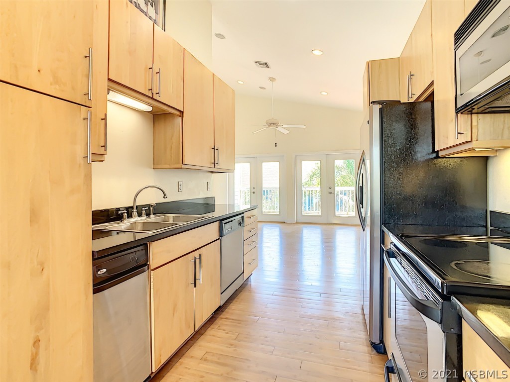 6273 Engram Road New Smyrna Beach, FL 32169 - Photo 15 of 34 a kitchen with stainless steel appliances granite countertop a sink and a stove