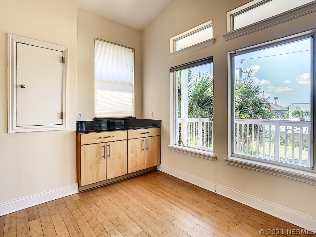 6273 Engram Road New Smyrna Beach, FL 32169 - Photo 17 of 34 a kitchen with granite countertop a stove and a window