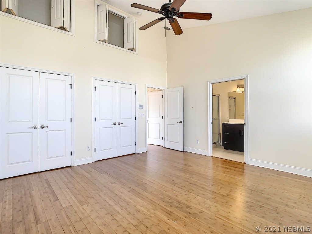 6273 Engram Road New Smyrna Beach, FL 32169 - Photo 21 of 34 a view of a room with wooden floor closet and windows