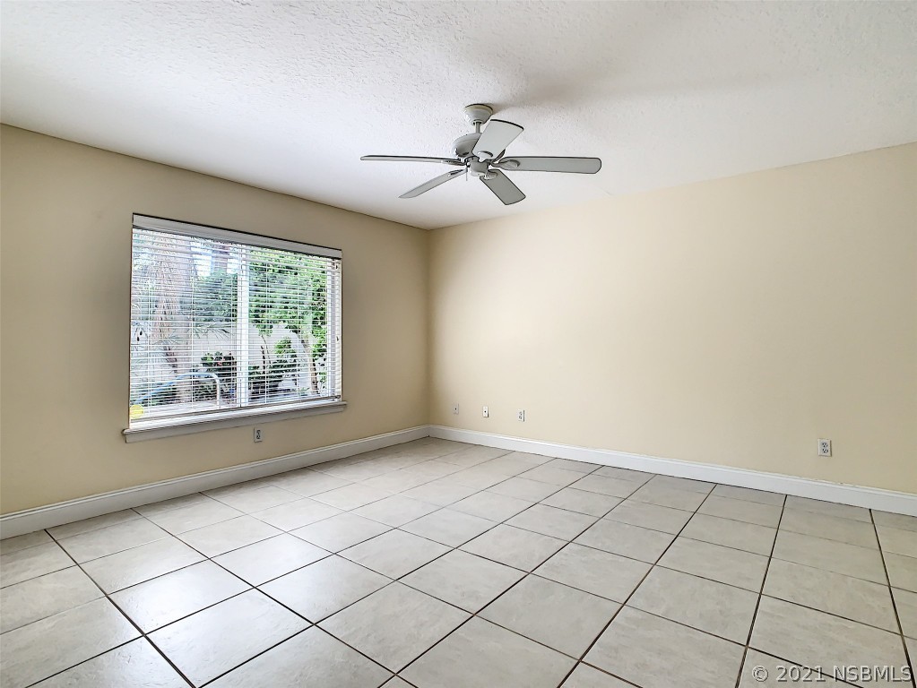 6273 Engram Road New Smyrna Beach, FL 32169 - Photo 25 of 34 an empty room with windows and ceiling fan