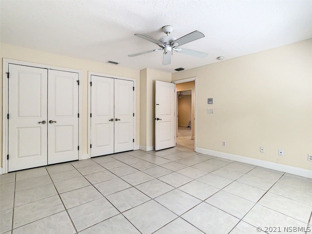 6273 Engram Road New Smyrna Beach, FL 32169 - Photo 27 of 34 an empty room with closet and a chandelier fan