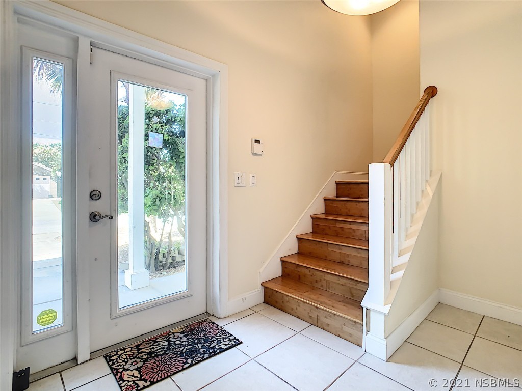 6273 Engram Road New Smyrna Beach, FL 32169 - Photo 4 of 34 a view of entryway with wooden floor and stairs