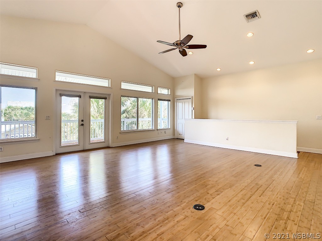 6273 Engram Road New Smyrna Beach, FL 32169 - Photo 7 of 34 a view of an empty room with a window and wooden floor