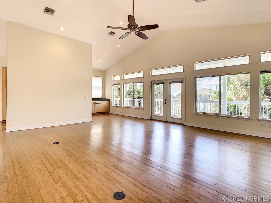 6273 Engram Road New Smyrna Beach, FL 32169 - Photo 8 of 34 an empty room with wooden floor and windows