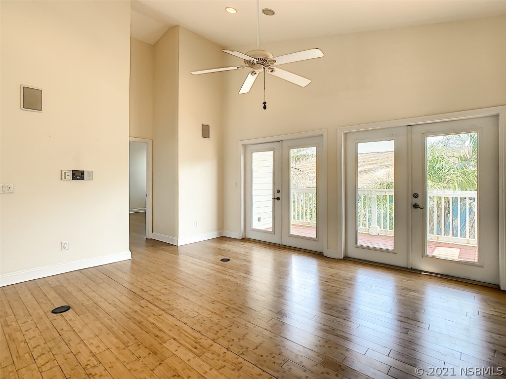 6273 Engram Road New Smyrna Beach, FL 32169 - Photo 9 of 34 a view of an empty room with a window and wooden floor
