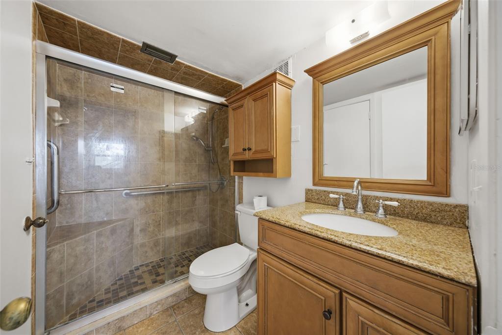 141 Fernery Road, Unit A3 Lakeland, FL 33809 - Photo 17 of 40 a bathroom with a granite countertop sink toilet and shower