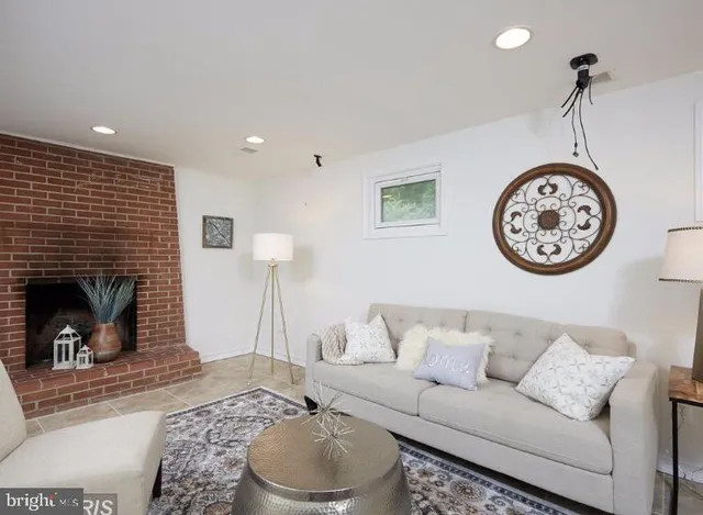a living room with furniture a clock and a fireplace
