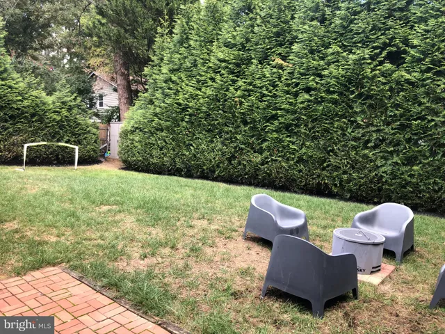 a backyard of a house with table and chairs
