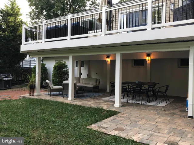 a view of a house with sitting area and garden