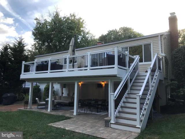 a front view of house with deck and outdoor seating