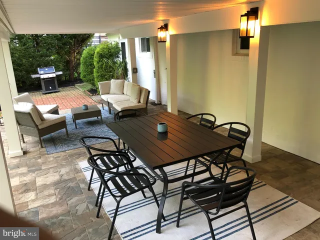 a outdoor space with a table and chairs