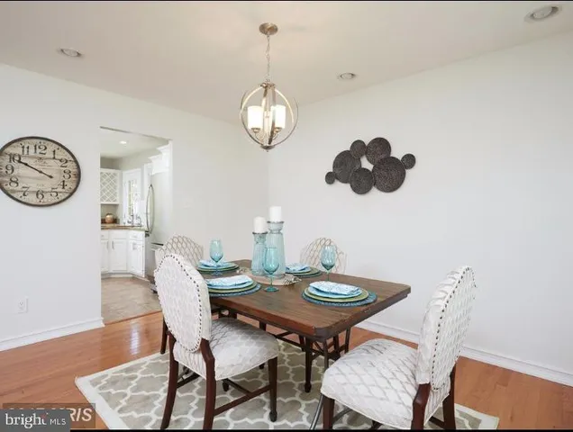 a view of a dining room with furniture wooden floor and a rug
