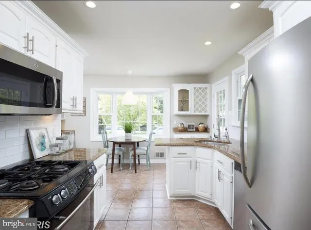a kitchen with a stove a sink and a refrigerator