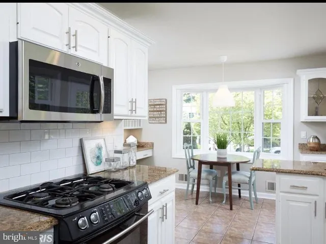 a kitchen with a stove a sink and a microwave