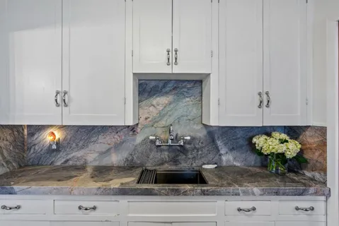 a kitchen with stainless steel appliances granite countertop a stove and a refrigerator