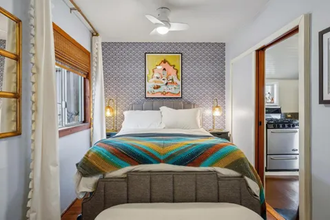 a bedroom with a bed and a large window