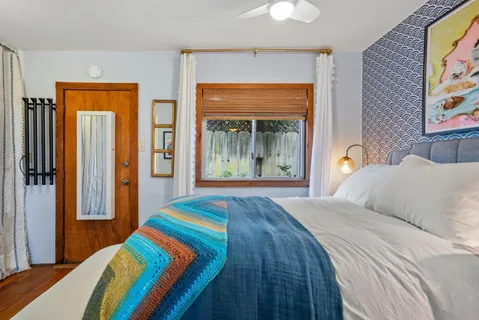 a bedroom with a bed and a large window