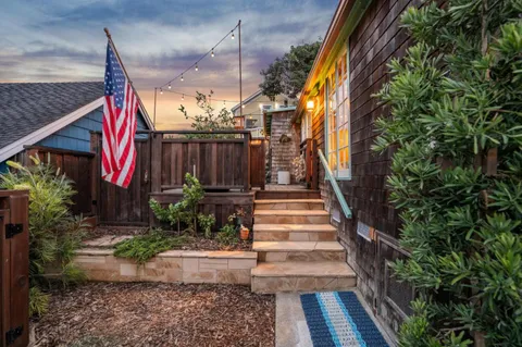 a view of a pathway of a house with a fountain